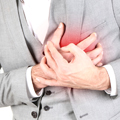 man holding his chest with red background on chest